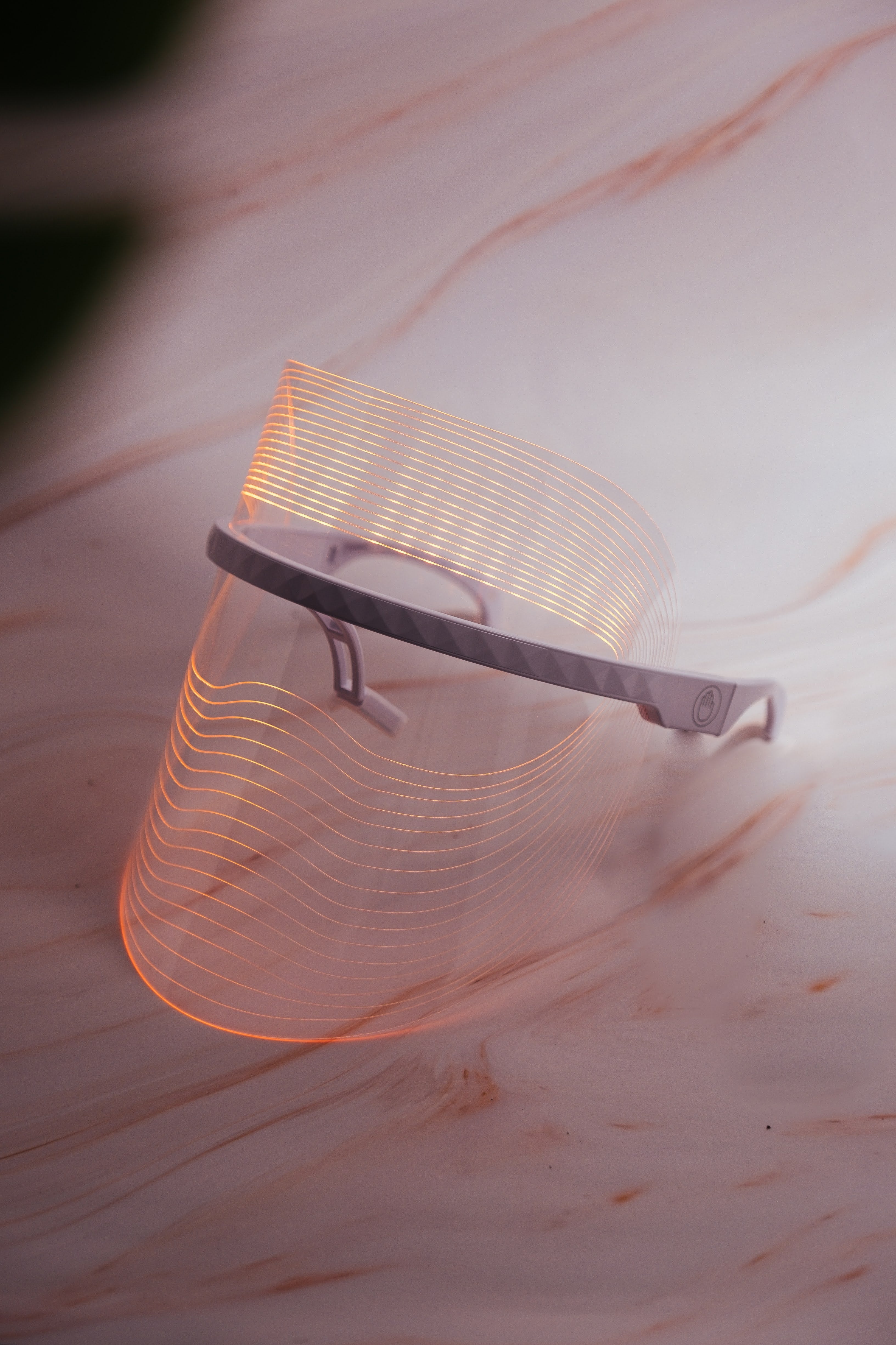 COCOON SKIN LED face mask side view showing clear visor and adjustable elastic strap