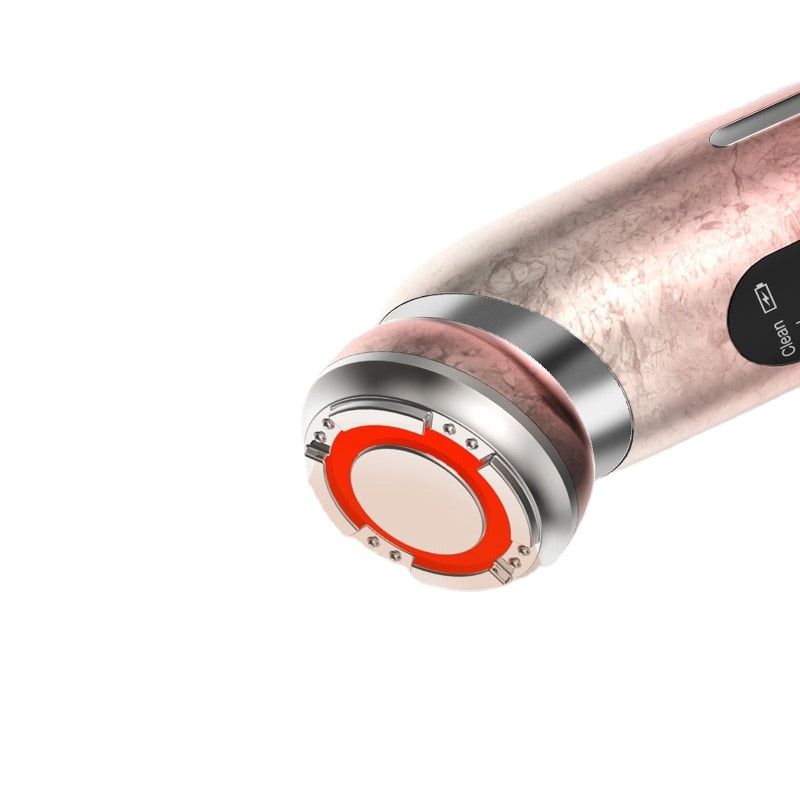 Close-up of the LED treatment head glowing red on a rose-gold EMS facial wand, showing the metal ring and texture