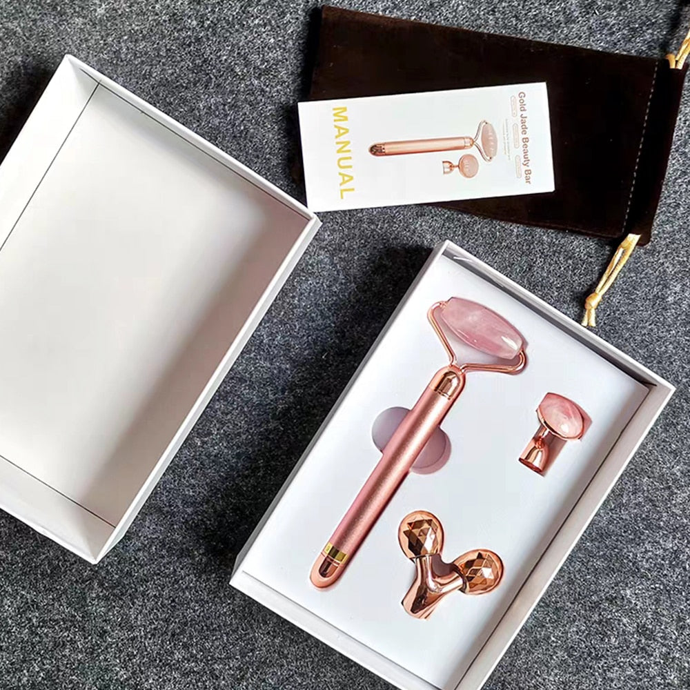 Gift box with electric rose-quartz facial roller handle and three interchangeable heads in a molded tray—premium packaging