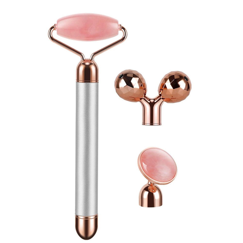 Rose quartz electric facial roller set with interchangeable heads—classic roller, dual-ball sculptor and eye stone, rose-gold accents.