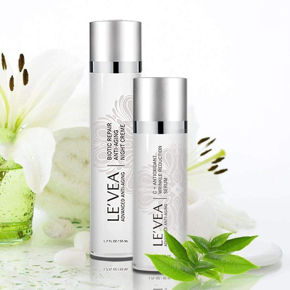 LEVEA Vitamin C Serum and Night Repair Cream styled with white florals on a clean background.