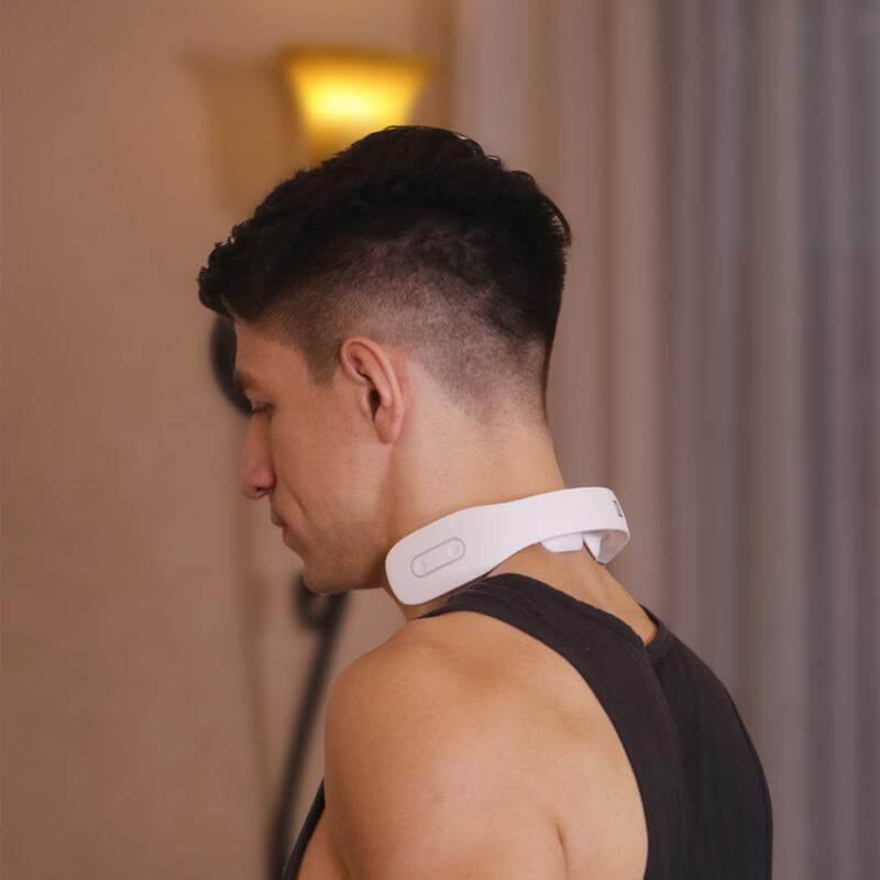 Man wearing the white K3 heated neck massager around the neck, showing ergonomic fit and wireless use