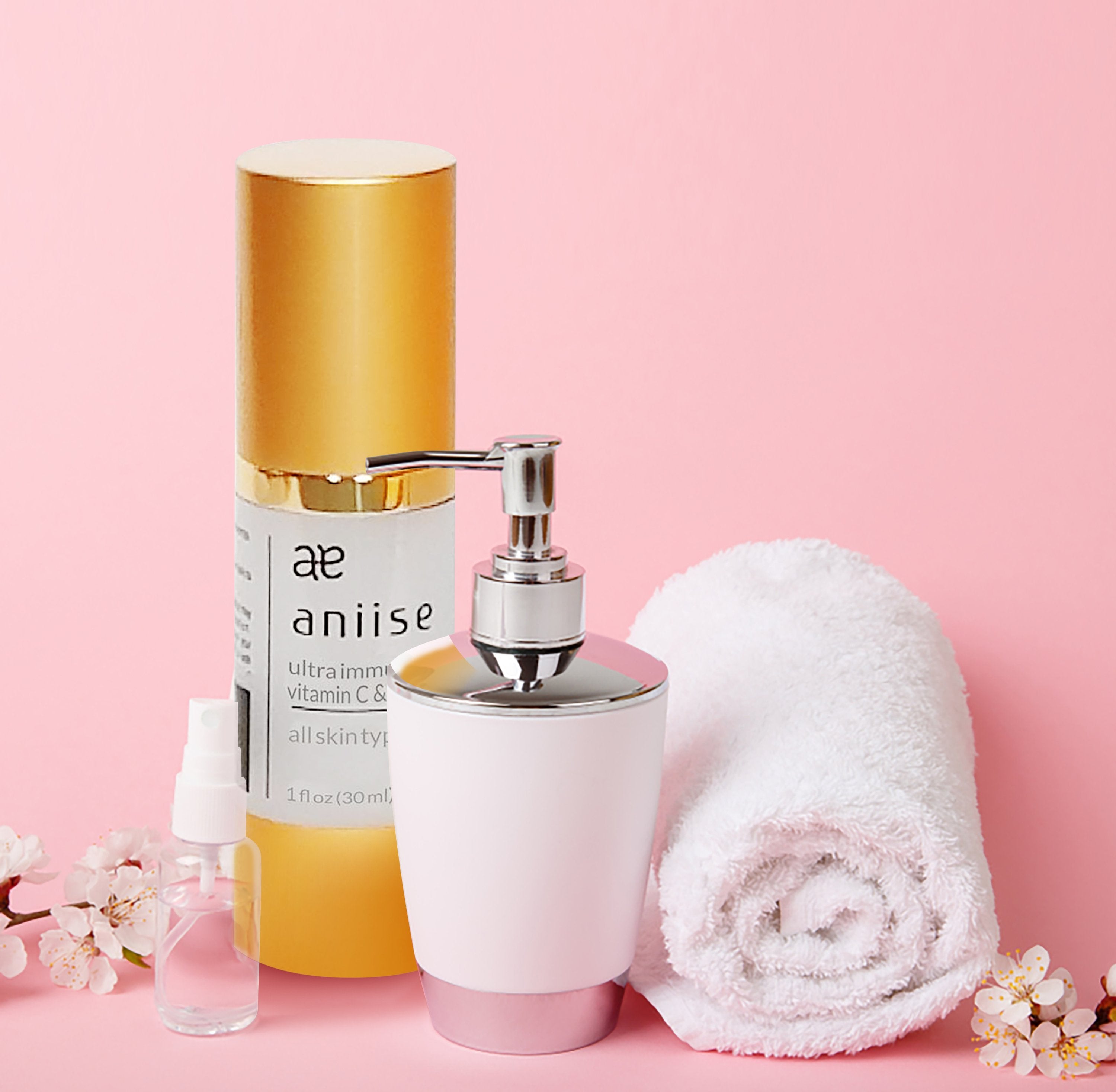 Aniise Vitamin C Serum on pink vanity with spa towel and dispenser